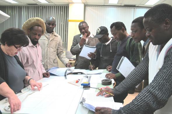 Fig. 3 – The teacher and the group of tailors working on an exercise.