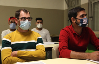 Vitali Siminionov (l) and Tajamal Abbas take Portuguese night classes at the school [Ana Naomi de Sousa/Al Jazeera]