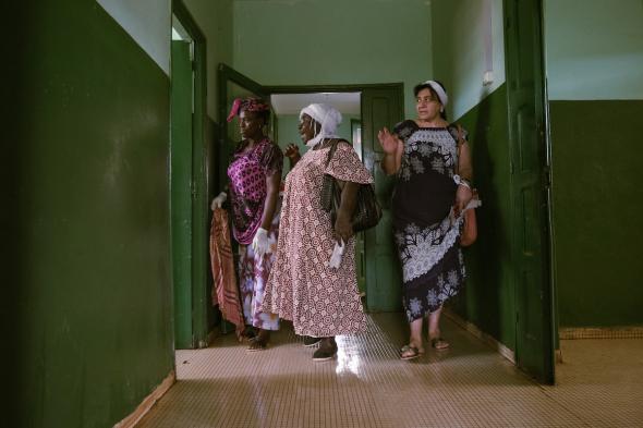 Fulacunda, Guinea Bissau (March 6, 2019) – Joana Gomes (center) instructs women cleaning the local hospital in Fulacunda, Guinea Bissau. Gomes, who was a medic on the frontlines during the independence war, donated beds to the hospital as part of her campaign. Image credit Ricci Shryock.