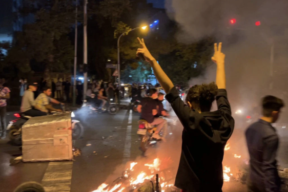 A picture obtained by AFP shows shows a demonstrator raising his arms and makes the victory sign during a protest for Mahsa Amini, a woman who died after being arrested by the Islamic republic's 'morality police,' in Tehran on Sept. 19, 2022. AFP via Getty Images